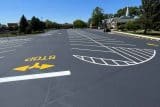 Empty parking lot with fresh lines and a church in the background.