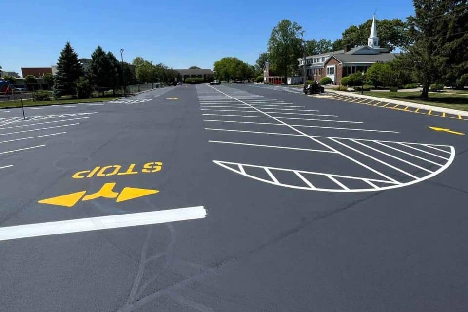 Empty parking lot with fresh lines and a church in the background.