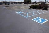 Blog: An empty lot with designated accessible parking spaces.